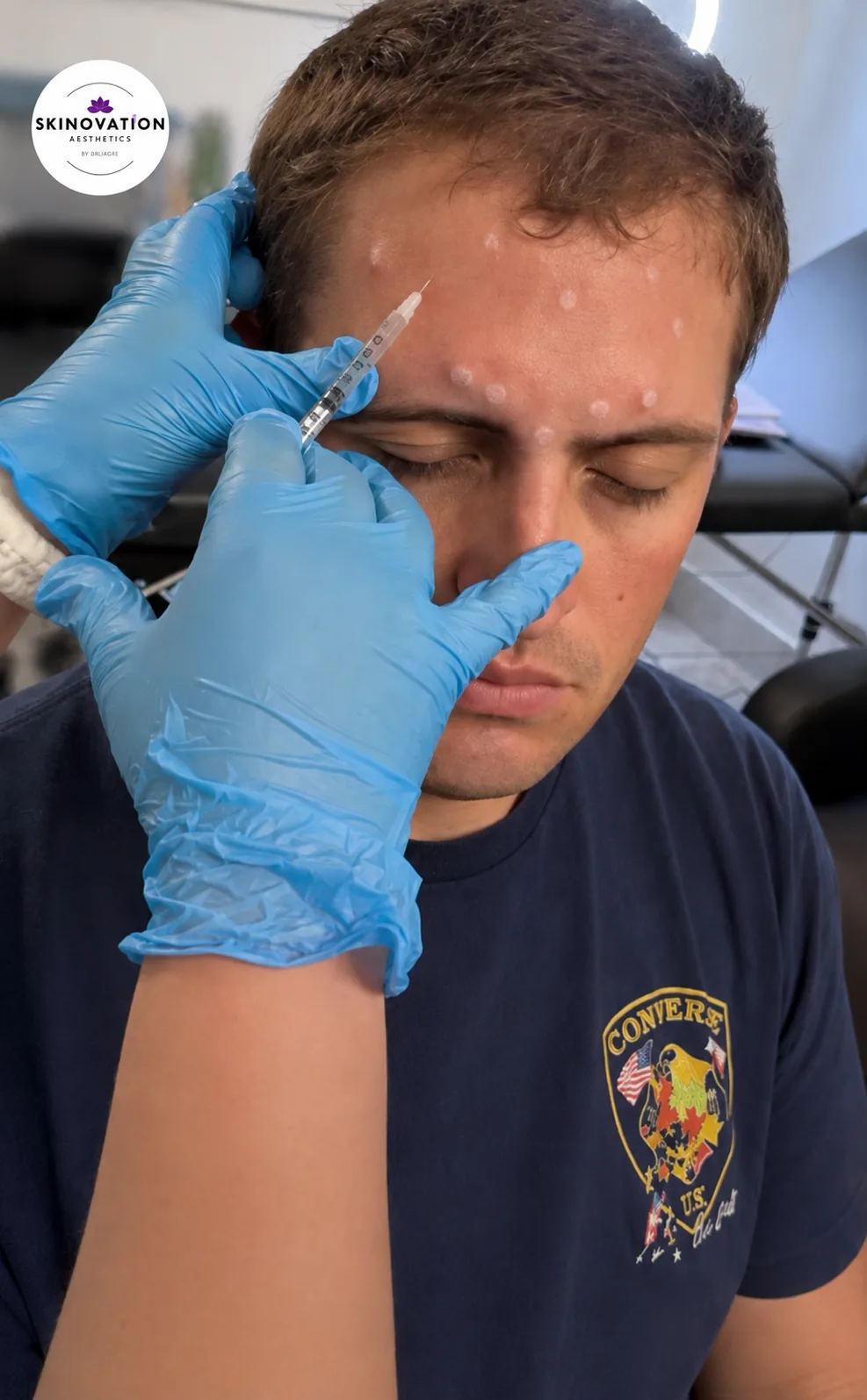 Medical provider administering a forehead injection to a male patient at Skinovation Aesthetics