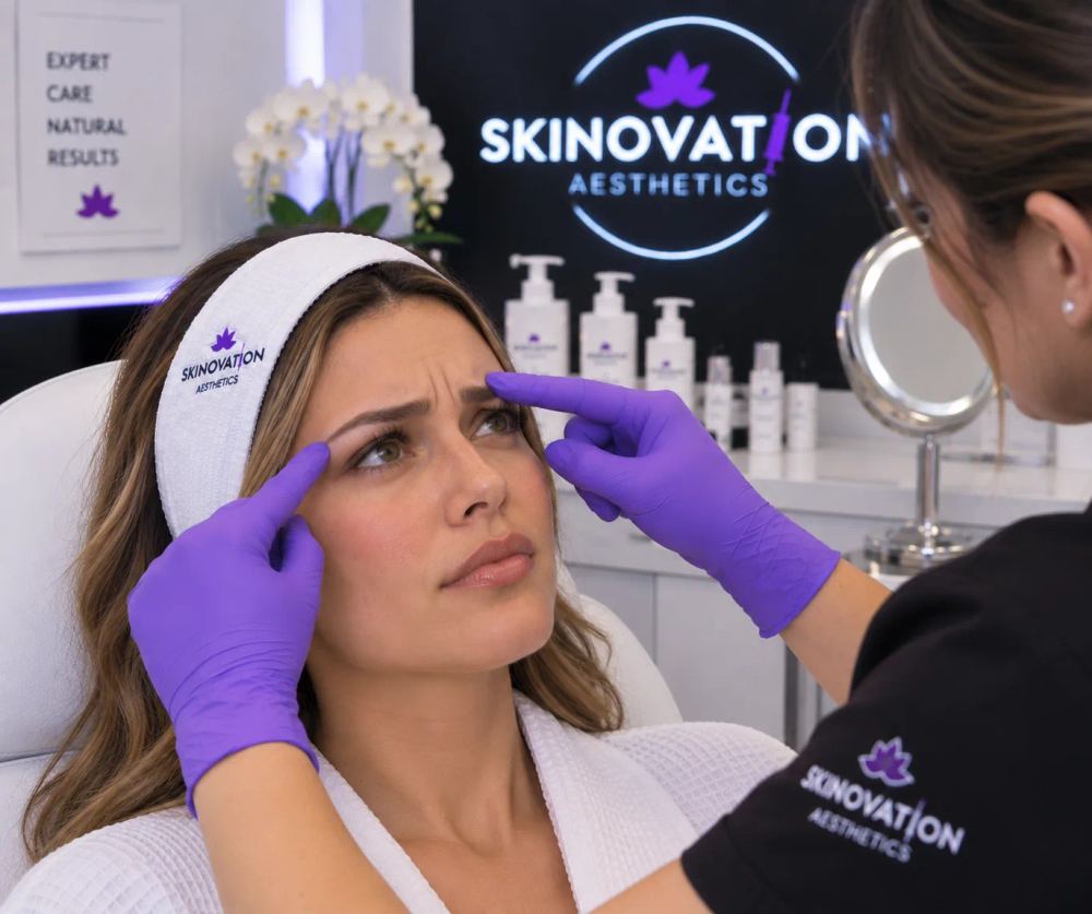 Skinovation Aesthetics provider assessing a patient's frown lines and forehead before Botox treatment